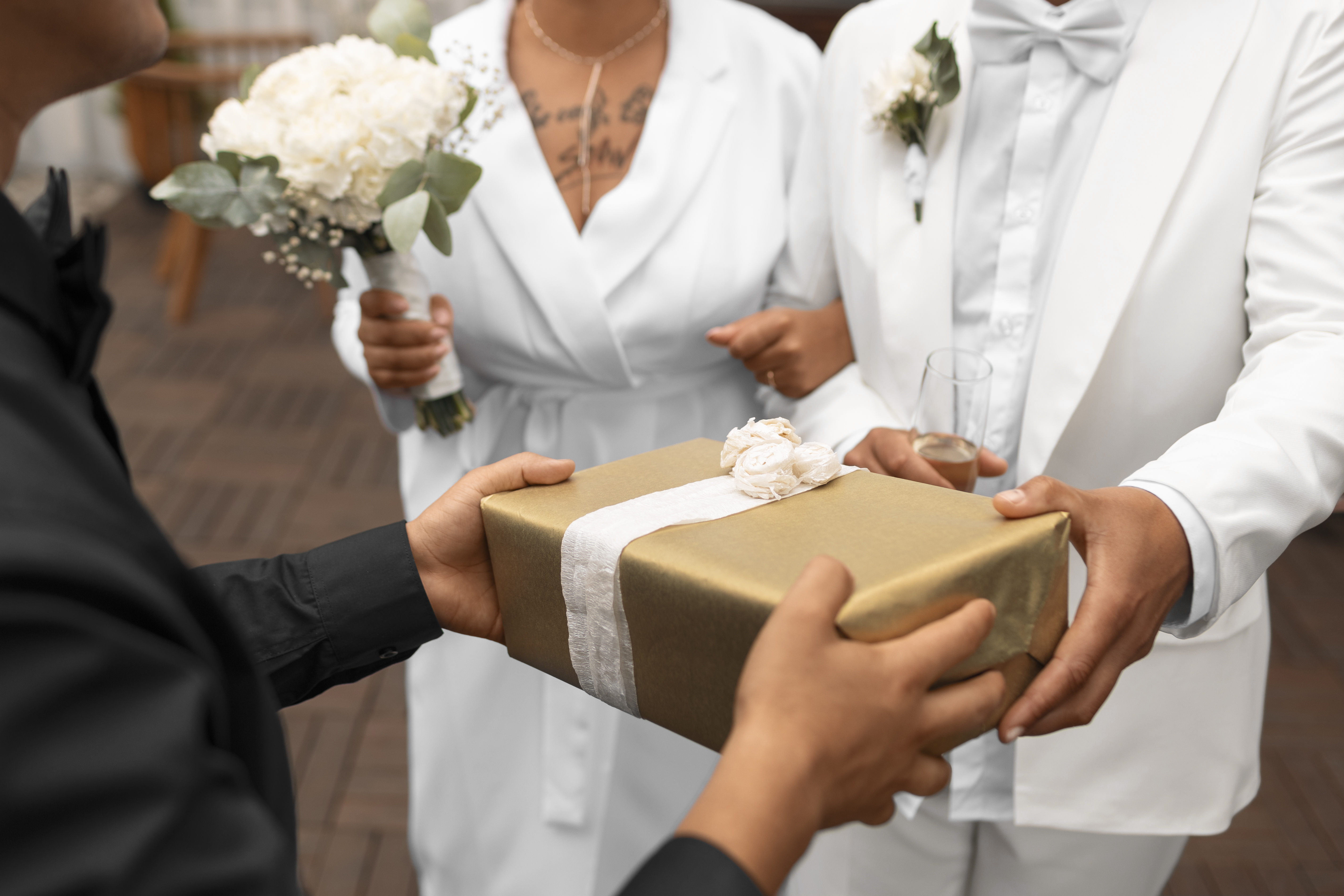 Guests presenting a wrapped wedding gift