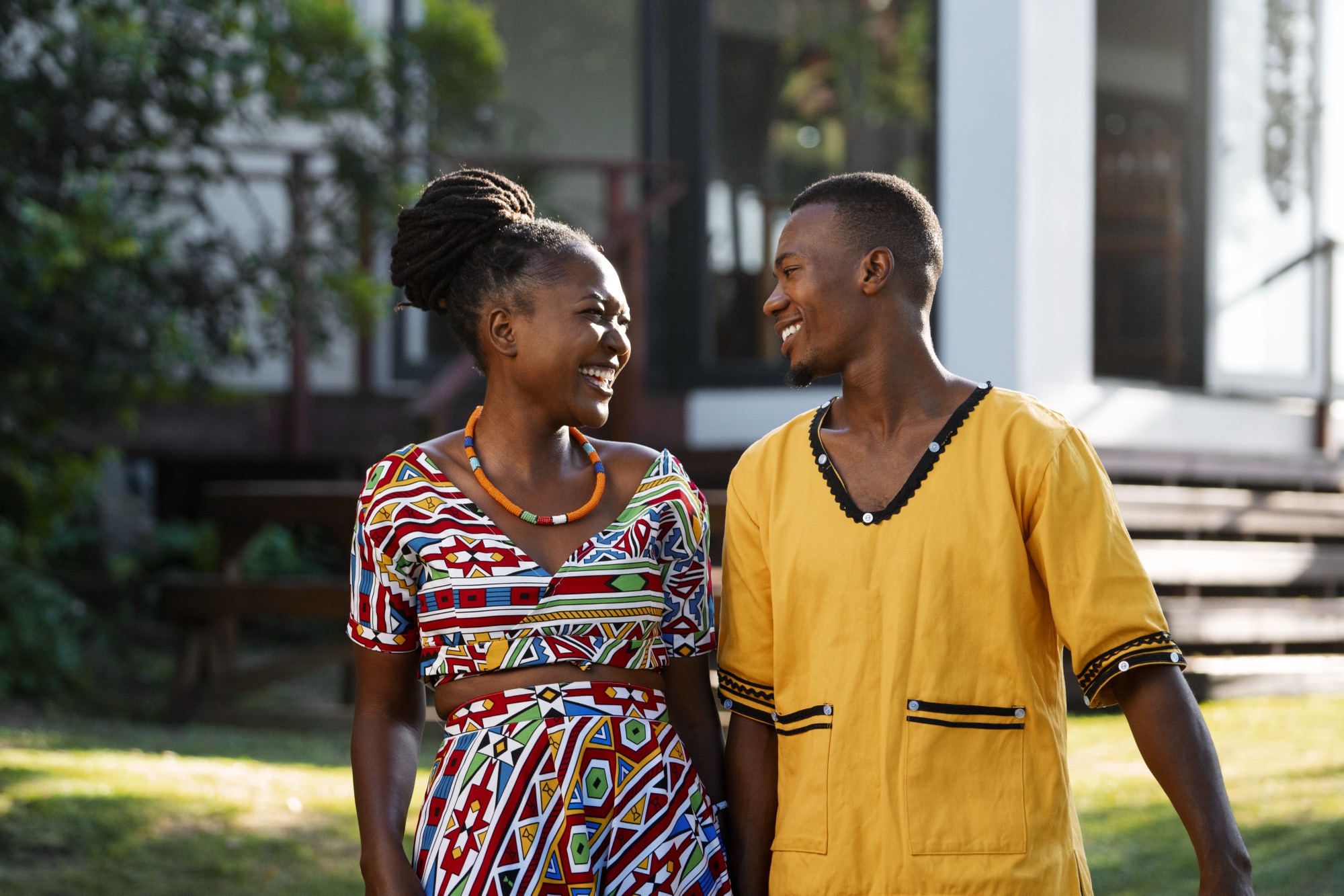 Engaged couple laughing together outdoors