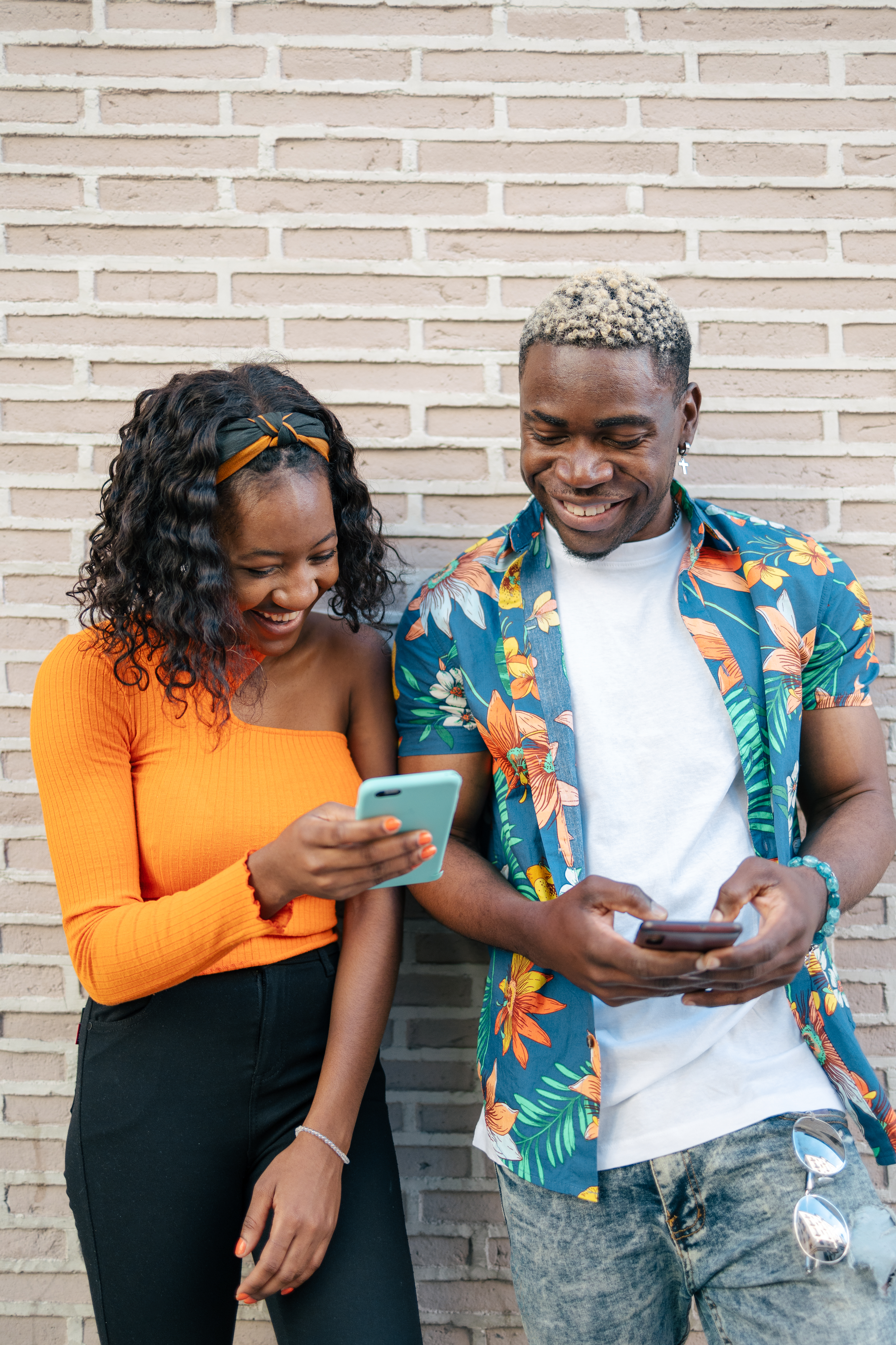 Couple happily planning together on their phones